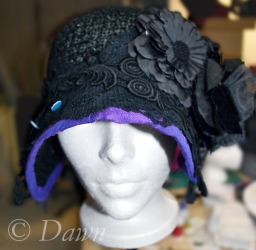 Auditioning different trims on the black straw cloche