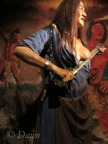 Round brooches on her shoulder at the Saga Museum  
