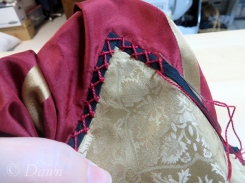Embellishing the black trim with red embroidery