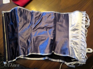 Three colours of the blue satin corset. The darkest blue is at the front, with the lightest at the back.