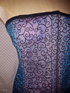 Blue flocked overbust corset. Close up taken with flash so you can see the pink fabric underneath.