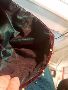 hand-stitching the lining of the horned hennin into the hat