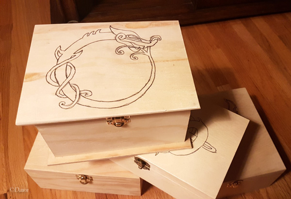 Boxes from the dollar store with Viking - inspired designs transferred onto the lids with carbon paper.