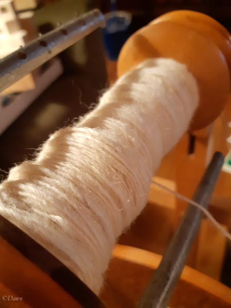 Two-ply handspun Romney natural white wool yarn on the borrowed Mason Wheel