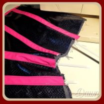 Sliding the bones into the internal bone casings (carried in the interlining) on the pink & snakeskin PVC underbust corset
